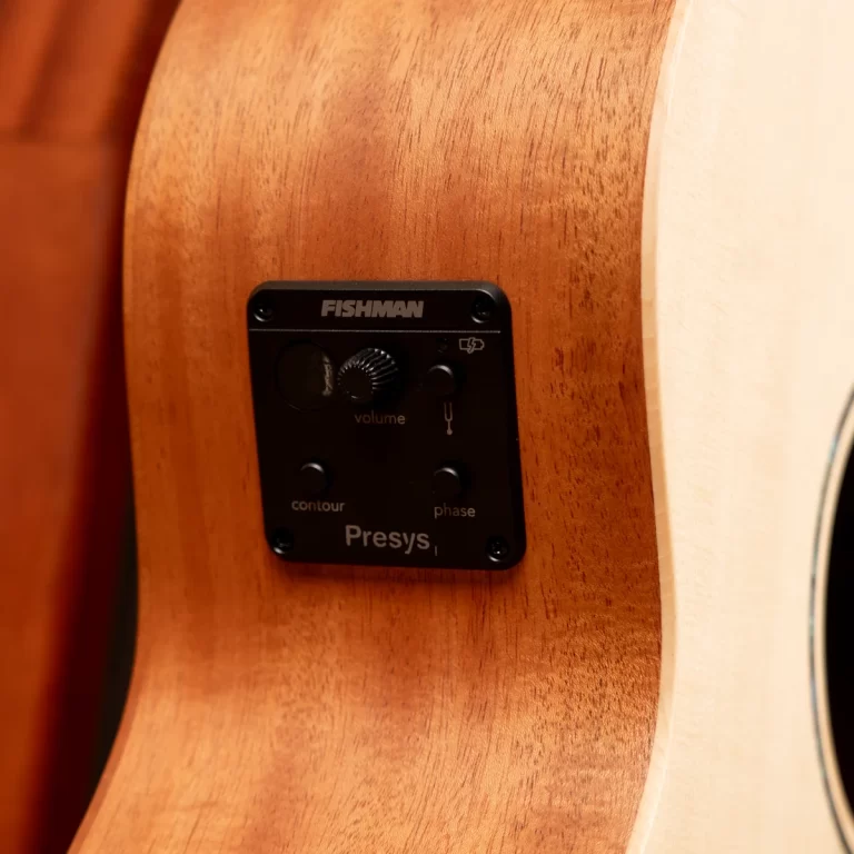 Close-up of a Fishman Presys preamp panel mounted on a wooden acoustic guitar side, showing knobs and labels (volume, contour, phase). ขายราคาพิเศษ