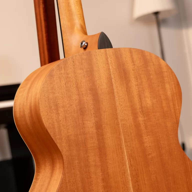 Back view of an acoustic guitar with a natural wood finish, showing the curved body and neck joint ขายราคาพิเศษ