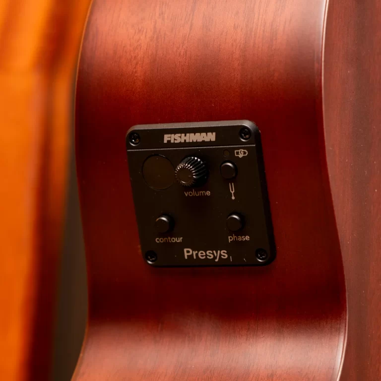 Close-up of a Fishman Presys control panel mounted on a wooden acoustic guitar body, showing volume, contour, phase, and input icons. ขายราคาพิเศษ