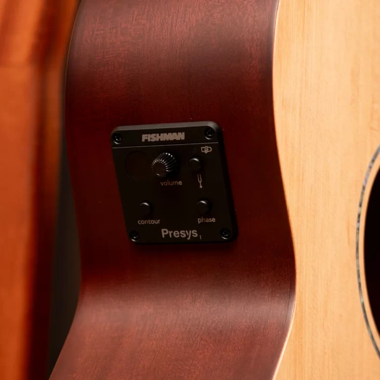 Close-up of a Fishman Presys preamp panel mounted on a brown acoustic guitar body, showing volume and contour controls. ขายราคาพิเศษ