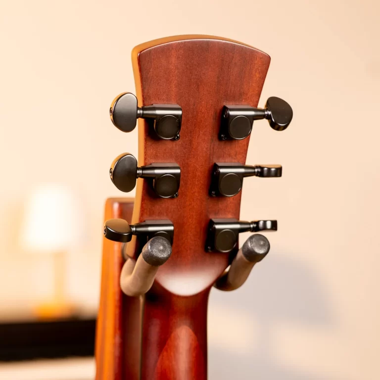 Back of a wooden guitar headstock with six black tuning pegs ขายราคาพิเศษ