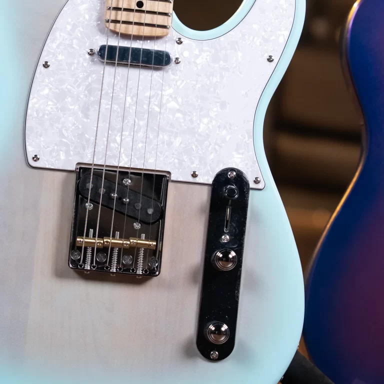 Close-up of a light-blue electric guitar with a pearloid white pickguard, single-coil pickup, and chrome bridge. ขายราคาพิเศษ