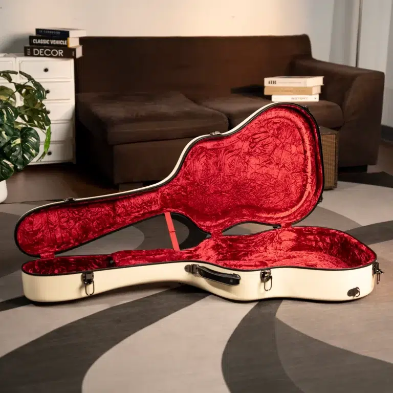 Open cream guitar case with red velvet interior resting on a gray rug in a living room. ขายราคาพิเศษ