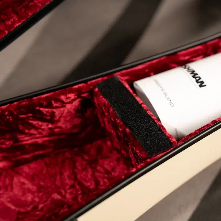 Close-up of a black-edged case with red velvet lining, showing a white card with partially visible black text inside the slot. ขายราคาพิเศษ