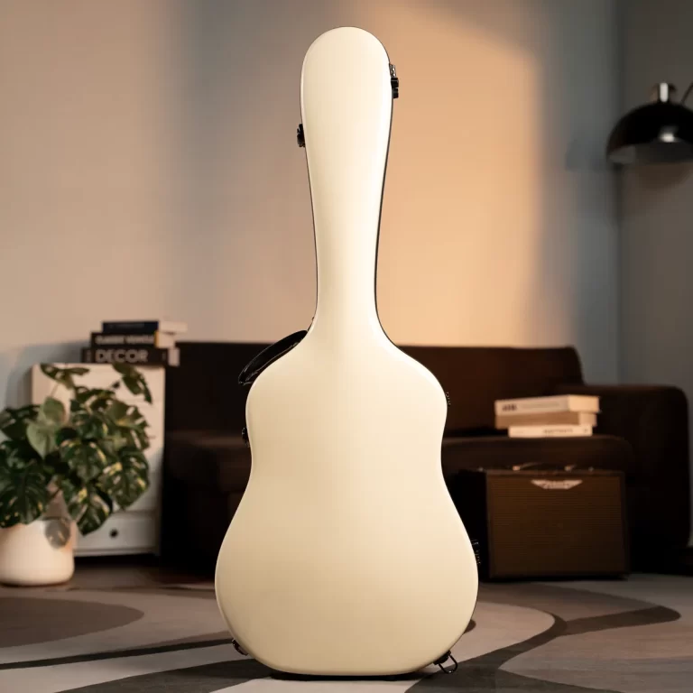 Cream-colored guitar case standing upright in a living room with a plant and sofa in the background. ขายราคาพิเศษ