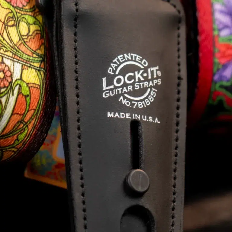 Close-up of a black leather guitar strap with 'Lock-It Guitar Straps' patent stamp and Made in USA. ขายราคาพิเศษ