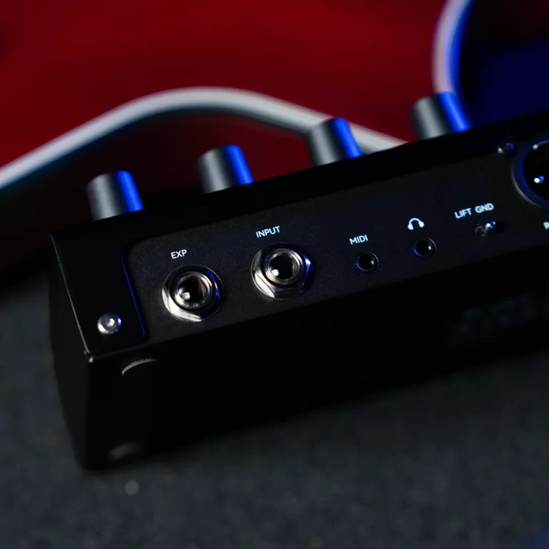 Audio interface front panel with EXP and INPUT jacks, MIDI and headphone ports, illuminated by blue accents ขายราคาพิเศษ