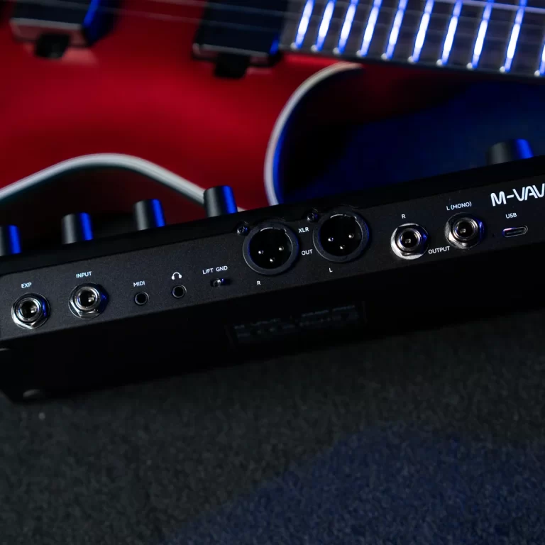 Close-up of an audio interface I/O panel with XLR and 1/4" jacks, MIDI and USB ports, and blue lighting in the background ขายราคาพิเศษ