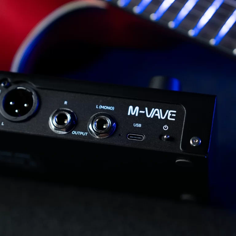 Close-up of a black M-VUE audio interface showing its rear panel with output jacks, USB port, and power switch. ขายราคาพิเศษ