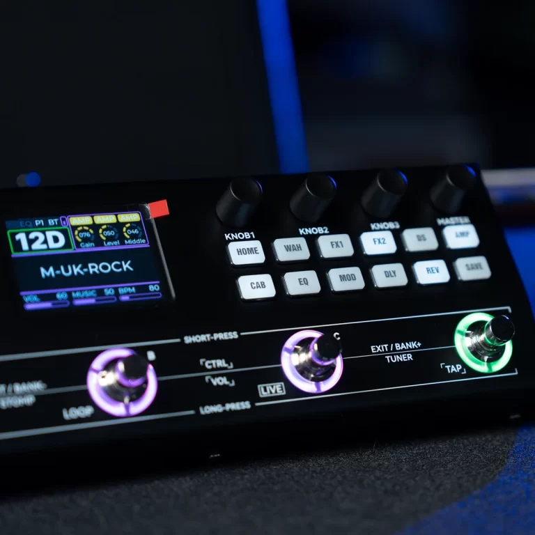 A close-up of a guitar multi-effects pedal with labeled knobs and a colored display reading 'M-UK-ROCK'. ขายราคาพิเศษ