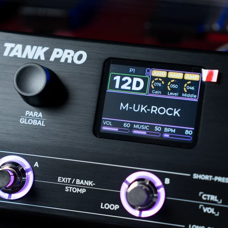 Close-up of a Tank Pro guitar effects pedal showing a color display with '12D' and 'M-UK-ROCK' and purple-lit knobs. ขายราคาพิเศษ