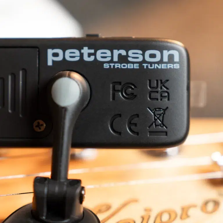 Close-up of a Peterson Strobe Tuners device mounted on a turntable, with the brand name visible and regulatory marks (CE/UKCA) beside a vinyl record surface. ขายราคาพิเศษ
