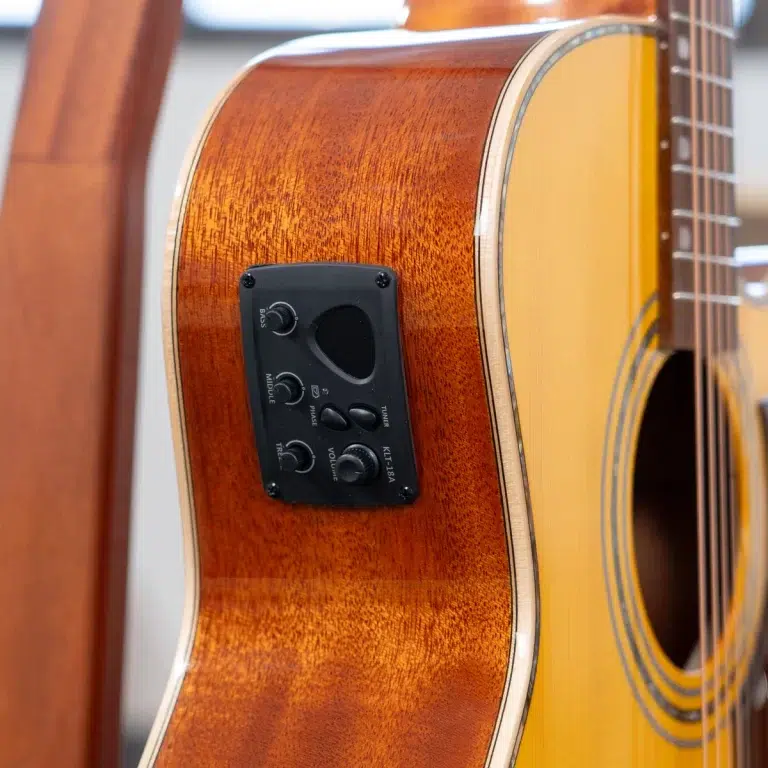 Acoustic guitar with a built-in control panel on the side, showing volume, tone, and phase knobs. ขายราคาพิเศษ