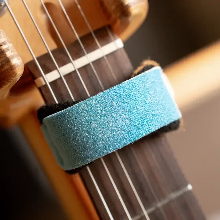 Blue foam string dampener/wrap placed around a guitar neck to mute or mute strings during practice or recording ขายราคาพิเศษ