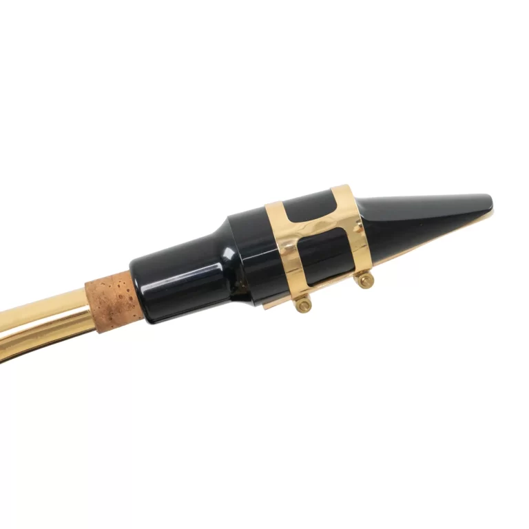 Close-up of a black clarinet mouthpiece with a gold ligature and cork reed on a white background ขายราคาพิเศษ