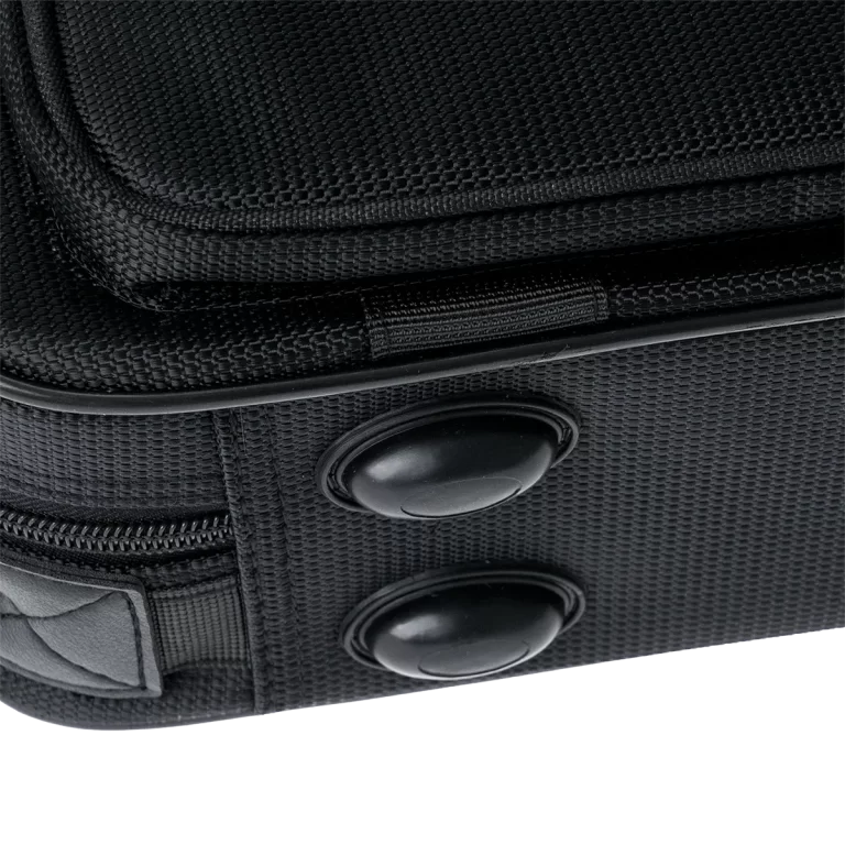 Close-up of a black fabric bag showing two round black snaps and a zipper seam for a luggage or backpack accessory ขายราคาพิเศษ