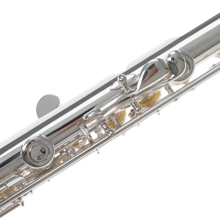 Close-up of a silver flute showing its keys, rods, and pads along the body. ขายราคาพิเศษ