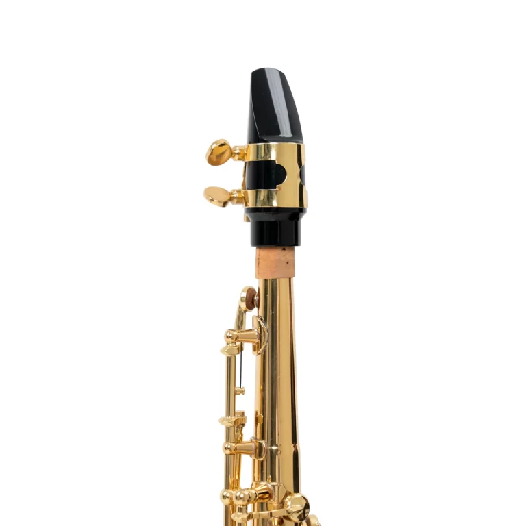 Close-up of a gold saxophone neck with its black mouthpiece and ligature band ขายราคาพิเศษ