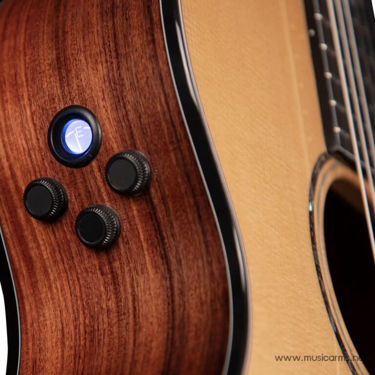 Close-up of an acoustic-electric guitar body with four black control knobs and a blue circular dial. ขายราคาพิเศษ
