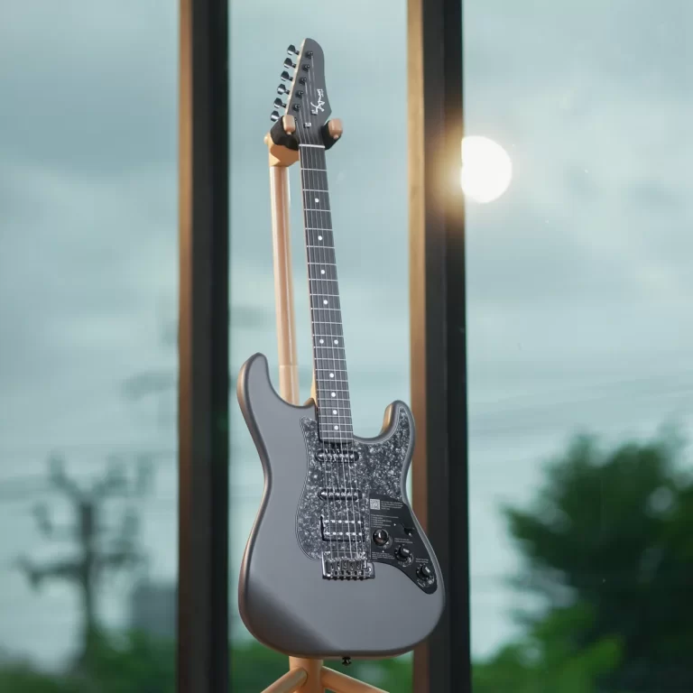 Gray electric guitar on a wooden stand by a large window, featuring a speckled pickguard and chrome hardware ขายราคาพิเศษ