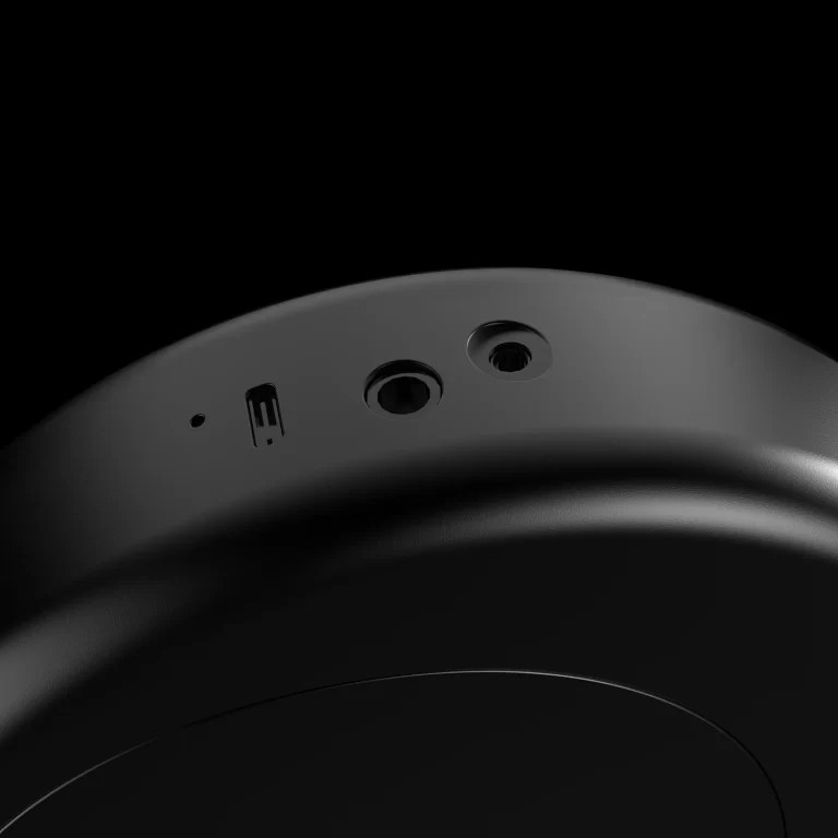 Close-up of a curved headphone band showing a USB-C port and two circular audio jacks against a dark background ขายราคาพิเศษ
