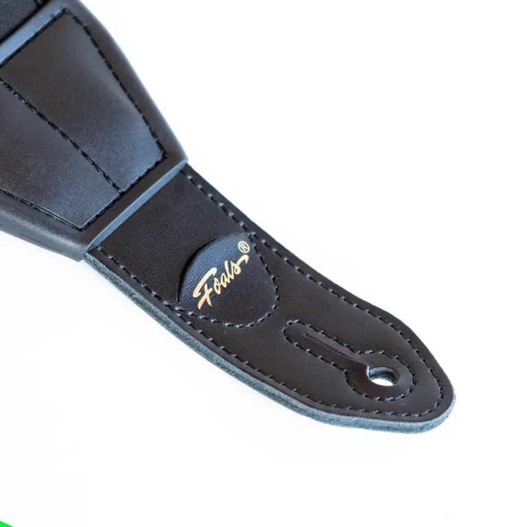 Close-up of black leather belt loop with gold embossed brand name Fabol ขายราคาพิเศษ