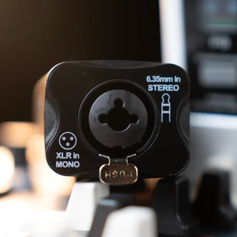 Black audio adapter panel showing 'XLR in MONO' and '6.35mm in STEREO' labels with circular input socket in the center and a small latch below ขายราคาพิเศษ