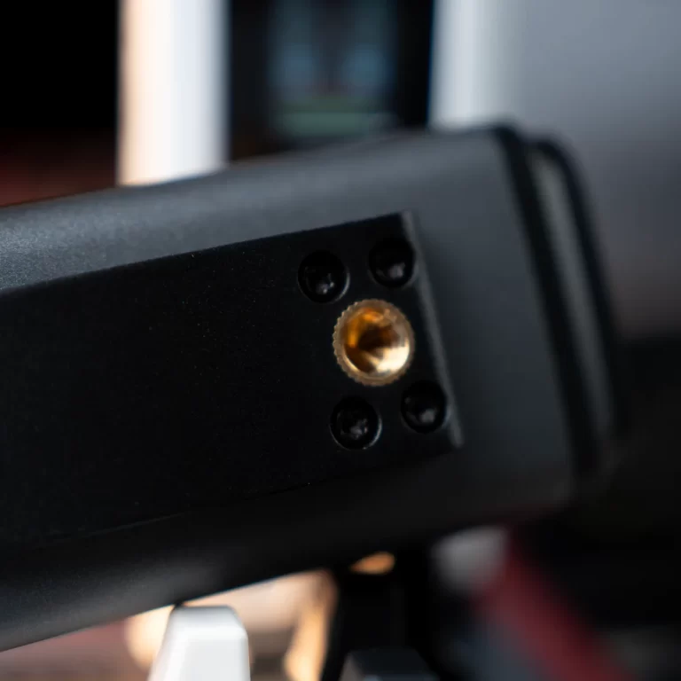 Close-up of a black device panel featuring a gold-plated circular connector port awaiting a cable connection. ขายราคาพิเศษ