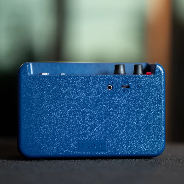 Blue textured back of a Laney portable amplifier, showing a USB-C port and two control knobs at the top edge. ขายราคาพิเศษ