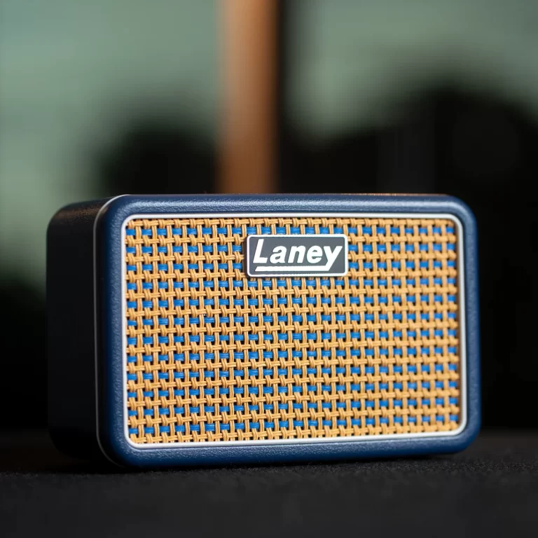 Close-up of a blue Laney guitar amplifier front with a woven tan grille and a prominent Laney badge in the center. ขายราคาพิเศษ