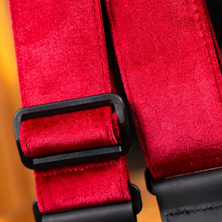 Close-up of red fabric straps with a black rectangular buckle, showing stitching and texture. ขายราคาพิเศษ