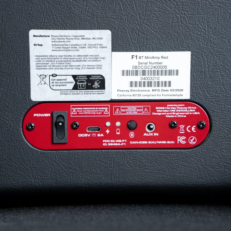 Red F1 BT MiniAmp back panel with power switch, input ports, and label stickers showing serial number and safety warnings. ขายราคาพิเศษ