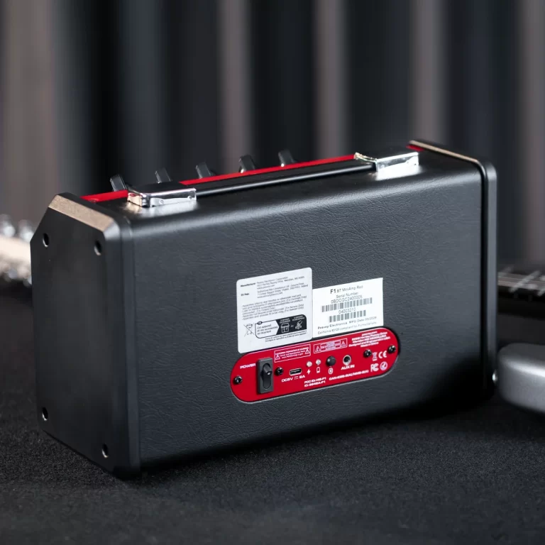 Rear view of a black guitar amplifier with a red control panel and stickers on the back. ขายราคาพิเศษ
