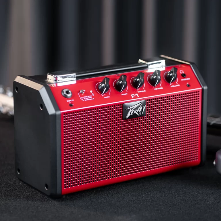 Red compact guitar amplifier with black side panels and control knobs for gain, bass, treble, and volume on top, Peavey logo on grille ขายราคาพิเศษ