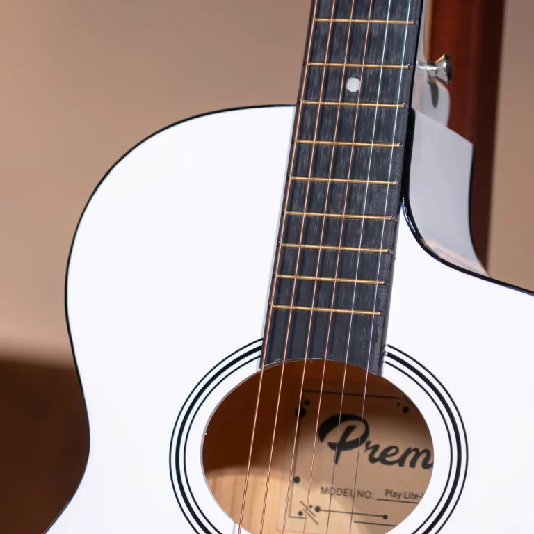 Close-up of a white acoustic guitar neck and strings with the sound hole visible and a Premier logo inside the hole ขายราคาพิเศษ