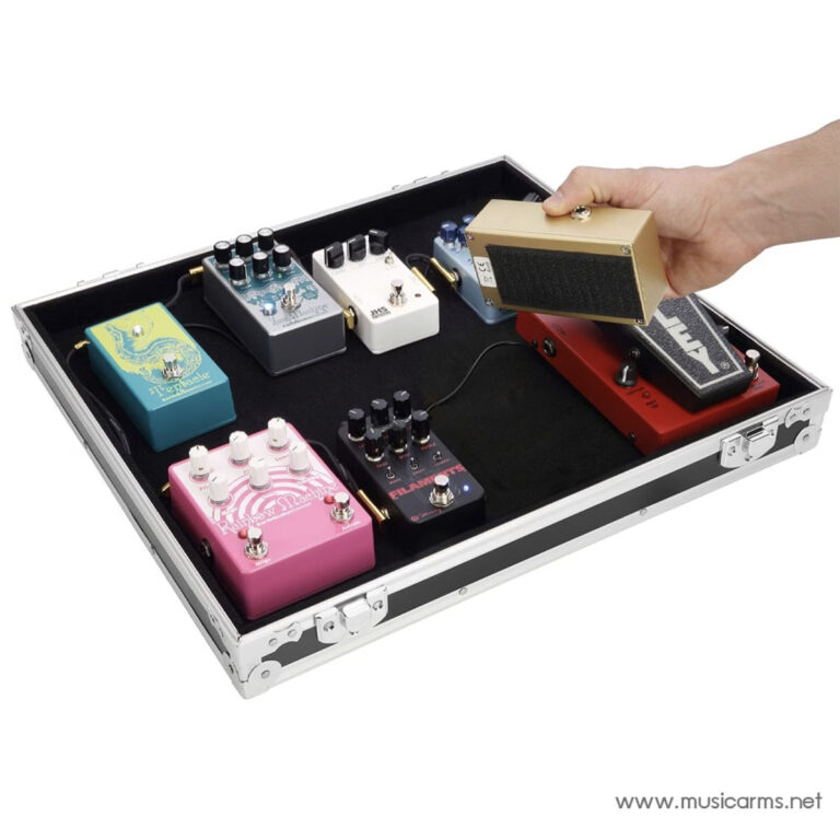 Person placing a gold guitar effects pedal onto a black pedalboard inside a silver case for a collection of colorful pedals ขายราคาพิเศษ
