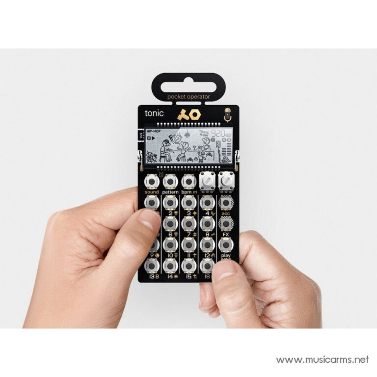 Hands hold a black Pocket Operator mini synthesizer with gray circular buttons and a small display, musicarms.net watermark visible at bottom right. ขายราคาพิเศษ
