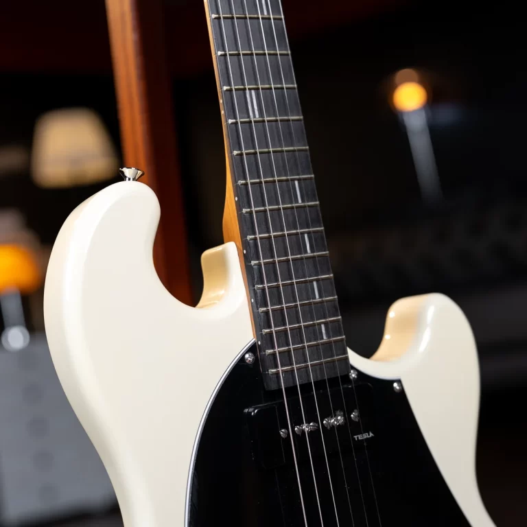 Close-up of a white electric guitar body and dark fretboard with strings and a black pickguard. ขายราคาพิเศษ