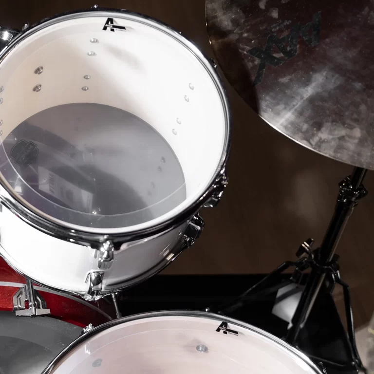 Close-up of a white drum shell with chrome hardware and a mounted cymbal on a stand in a drum kit. ขายราคาพิเศษ