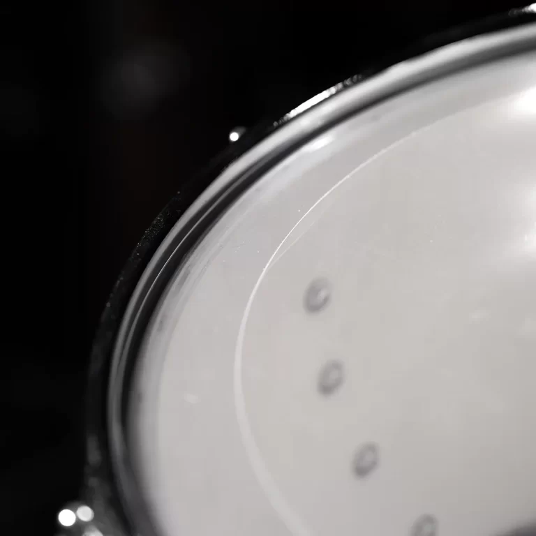 Close-up of a white circular clock face with small gray hour markers and a black bezel. ขายราคาพิเศษ