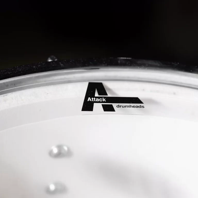 Close-up of a white drum head with the black Attack drumheads logo visible near the center. ขายราคาพิเศษ