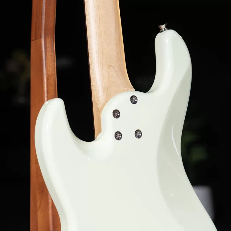 Close-up of a mint-green double-neck electric guitar, showing two wooden necks attached to the body with screws. ขายราคาพิเศษ