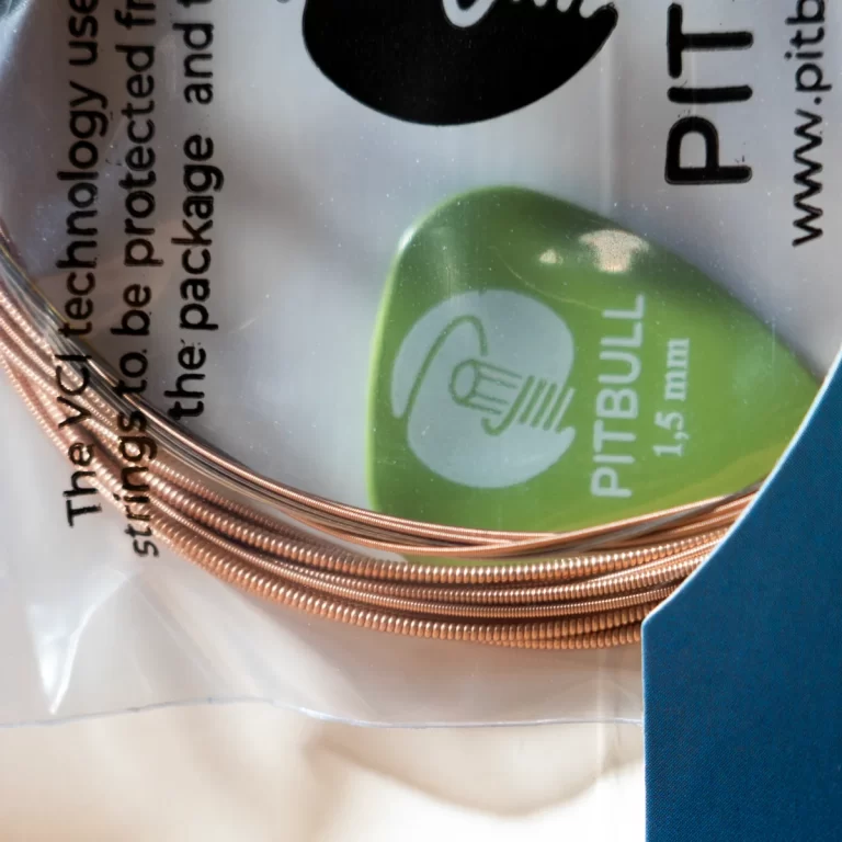 Close-up of a copper braided cable coiled on a plastic packaging, with a green circular label and partial text visible. ขายราคาพิเศษ