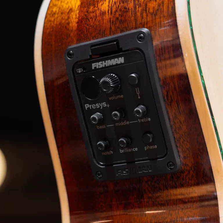 Close-up of a Fishman Presys+ preamp panel mounted on a glossy wooden acoustic guitar body. ขายราคาพิเศษ