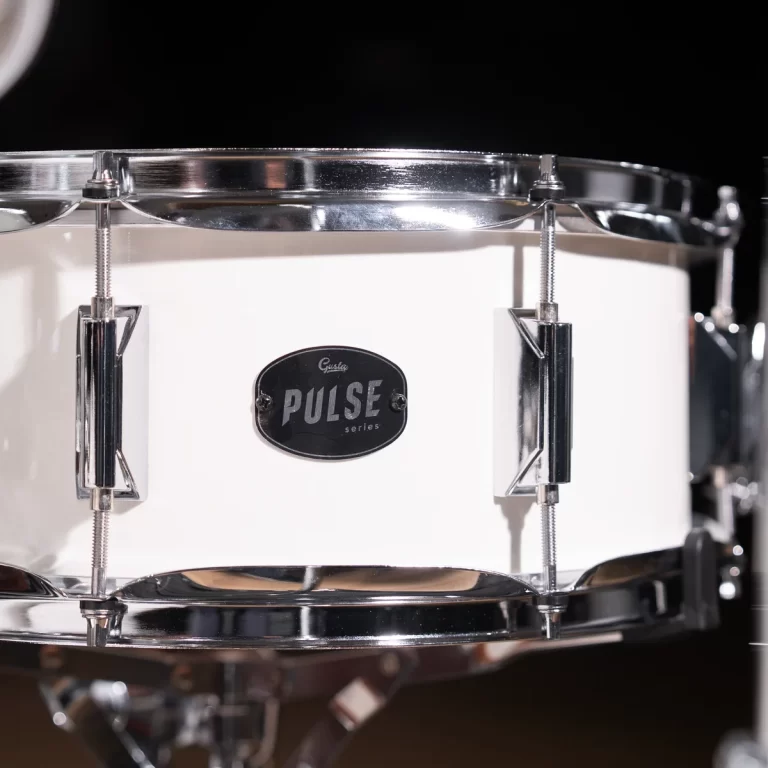 Close-up of a white snare drum with chrome hardware and a Pulse series badge visible on the shell. ขายราคาพิเศษ