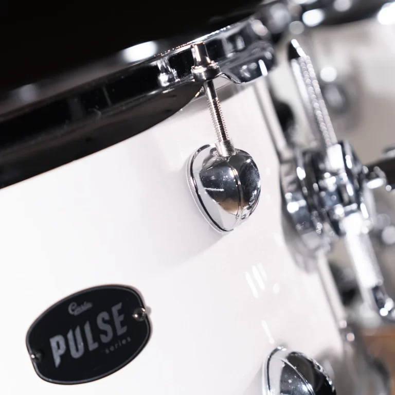 Close-up of a white drum shell with chrome hardware and a Pulse Series badge visible on the side ขายราคาพิเศษ