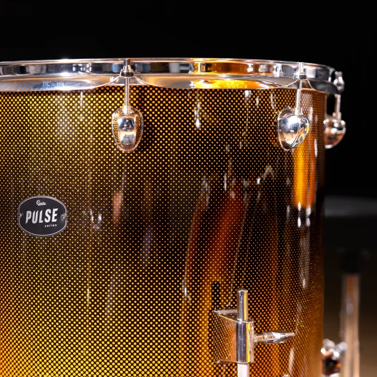 Close-up of a golden brown snare drum shell with a dotted finish, chrome hardware, and a Pulse series badge visible on the side. ขายราคาพิเศษ
