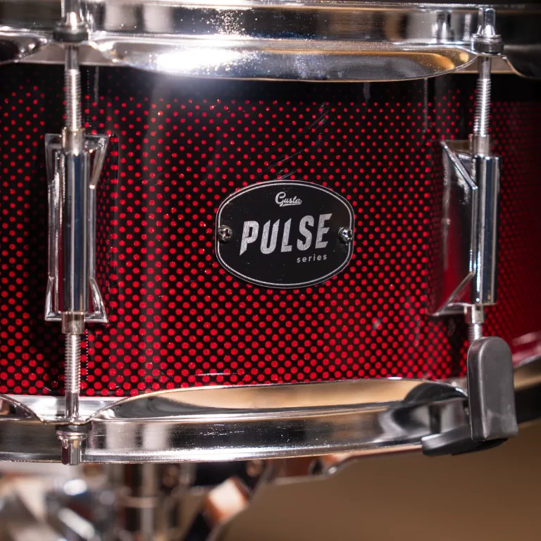 Close-up of a red dotted drum shell with chrome hardware and a 'Pulse' series badge in the center ขายราคาพิเศษ