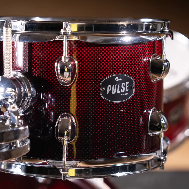 Close-up of a red sparkle snare drum with chrome hardware and a Pulse badge visible. ขายราคาพิเศษ