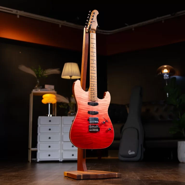 Red electric guitar on a wooden stand in a dimly lit music studio showroom. ขายราคาพิเศษ